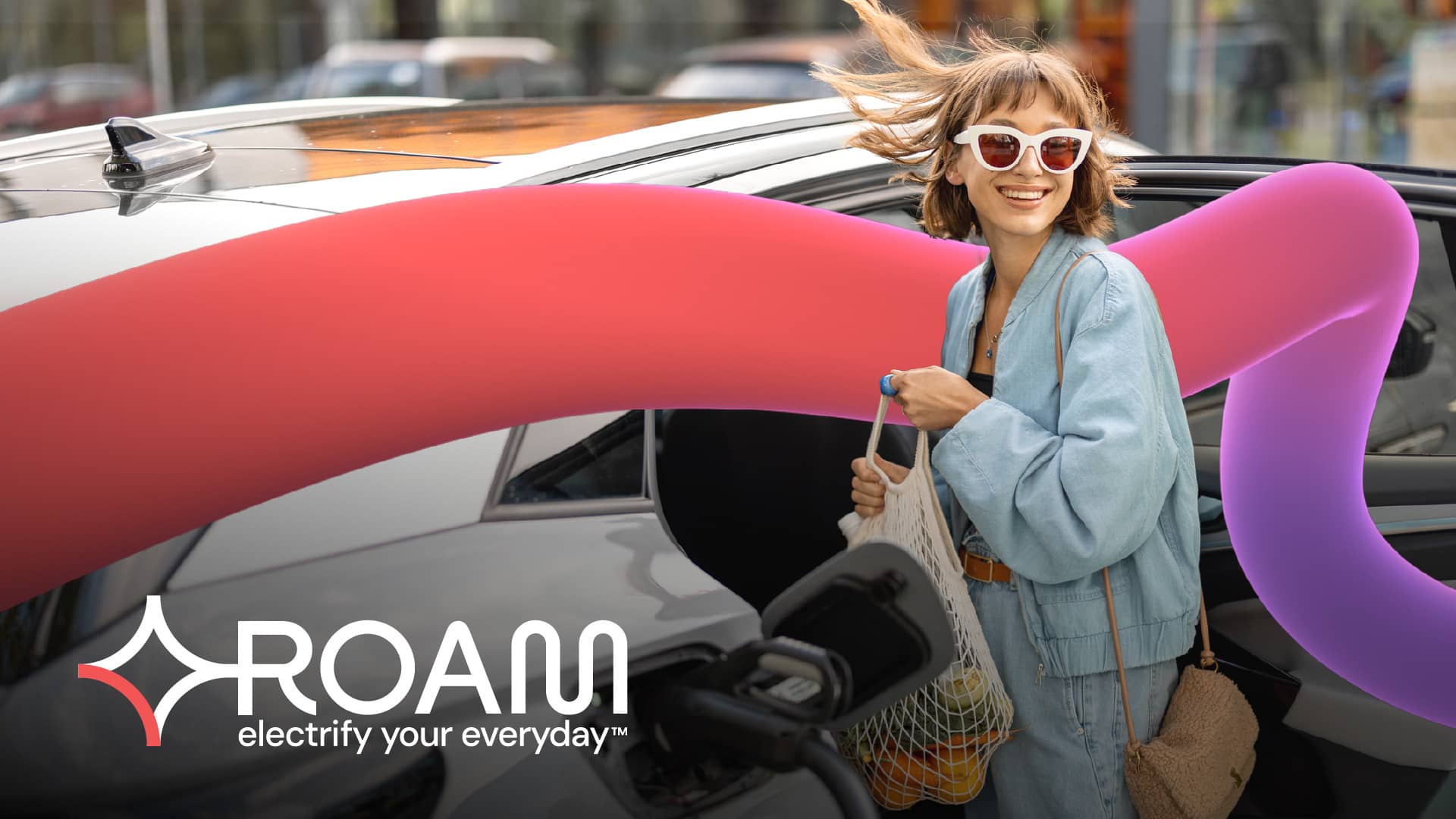 Woman staying next to the car, logo Roam