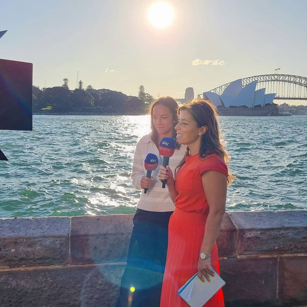 Couple of women talking to camera with Sidney Opera building in background