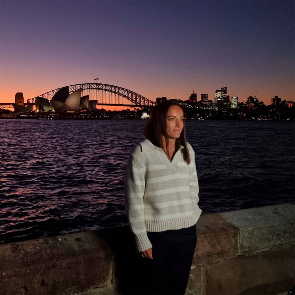 Posing woman in late evening with Sidney Opera building in background