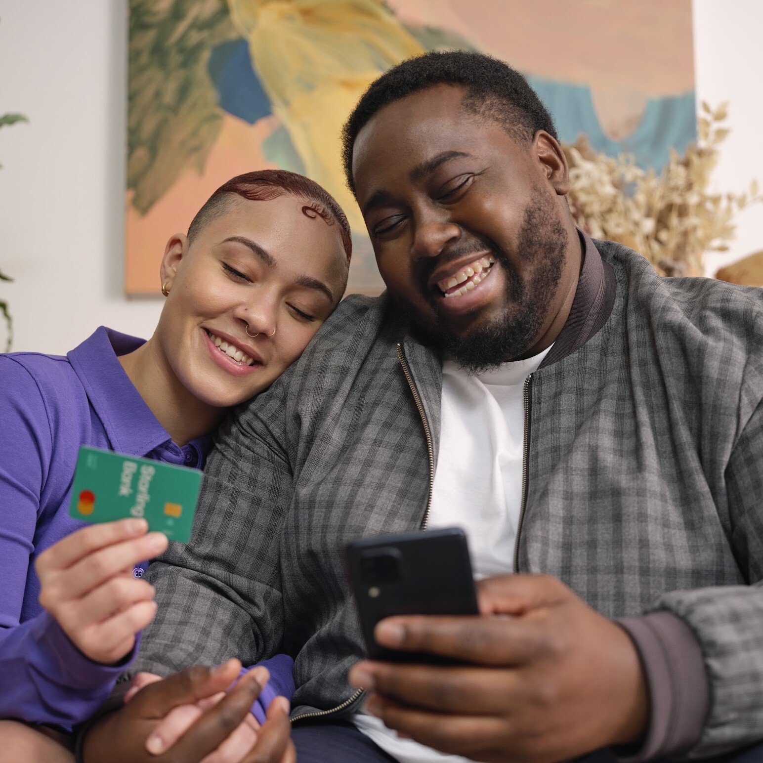 A man and a lady on a chair with a Starling card