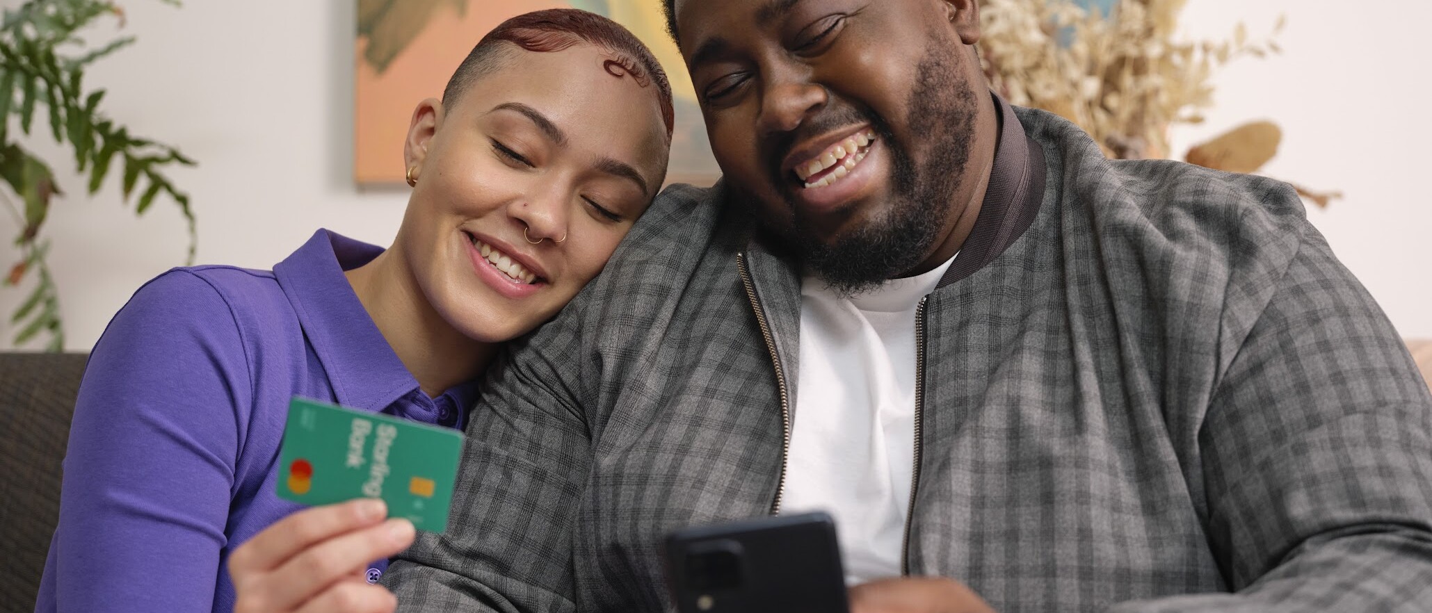 A man and a lady on a chair with a Starling card