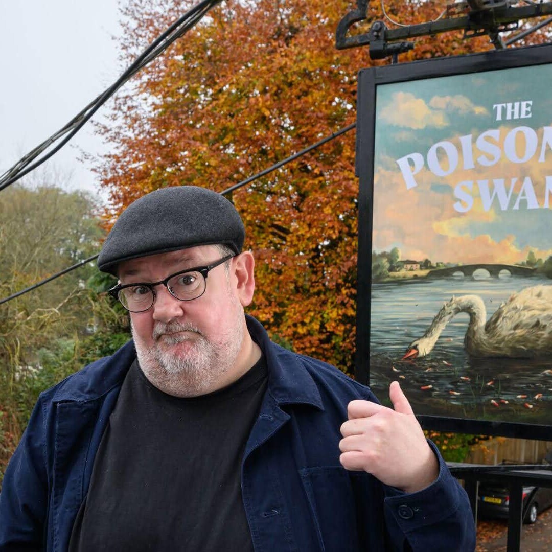 Man staying in front of pub sign