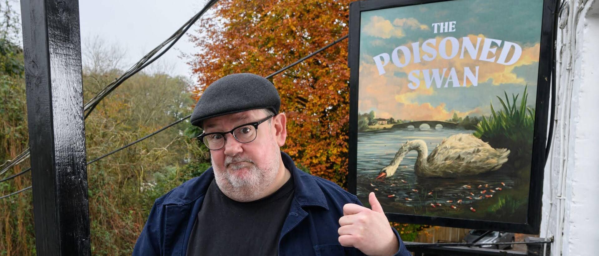 Man staying in front of pub sign