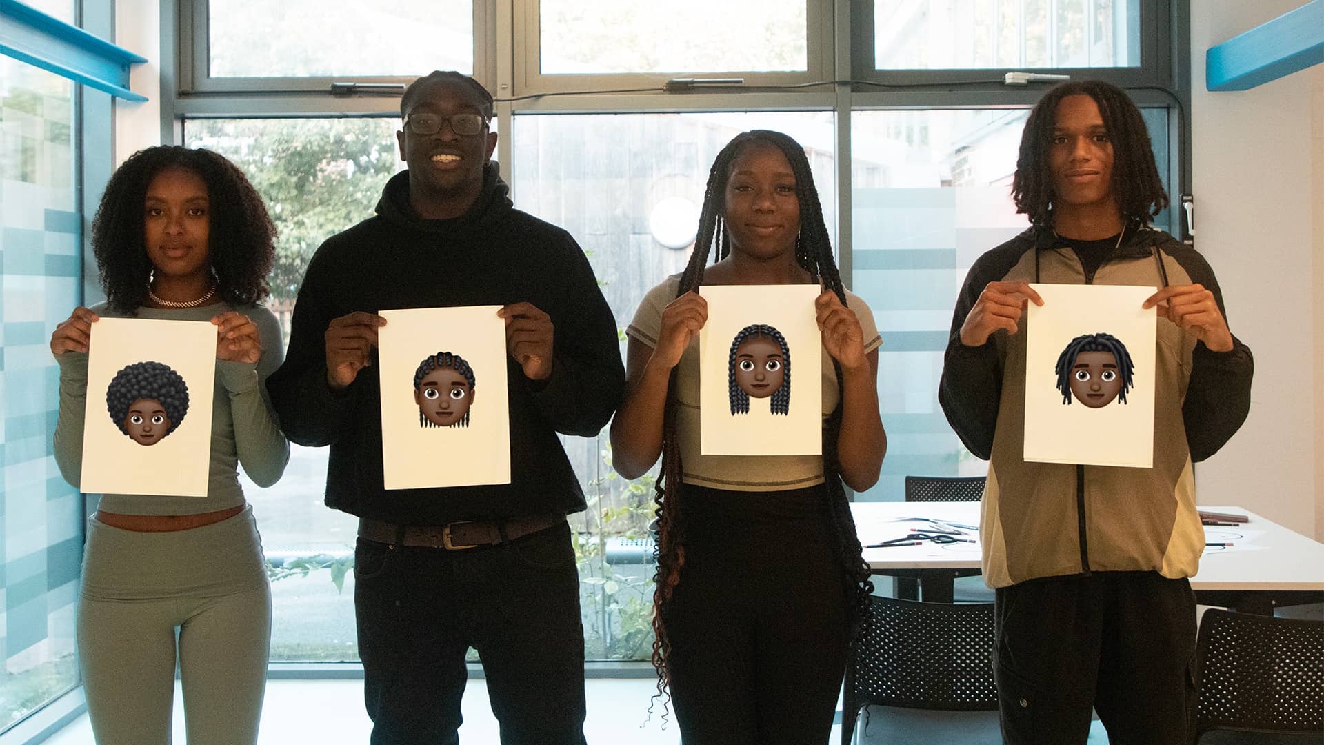 Group of people holding hearmoji sketches