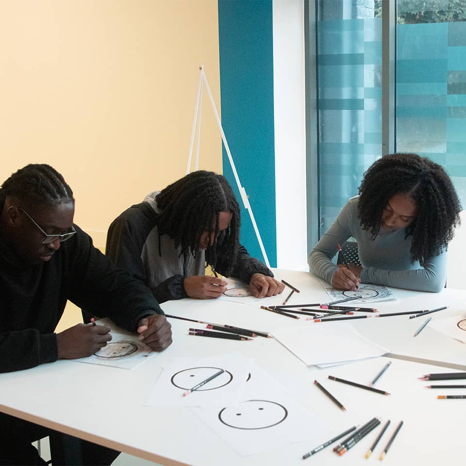 Group of people drawing hearmoji sketches