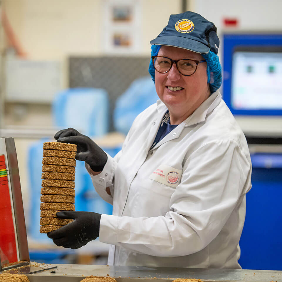 A lady holding some Weetabix