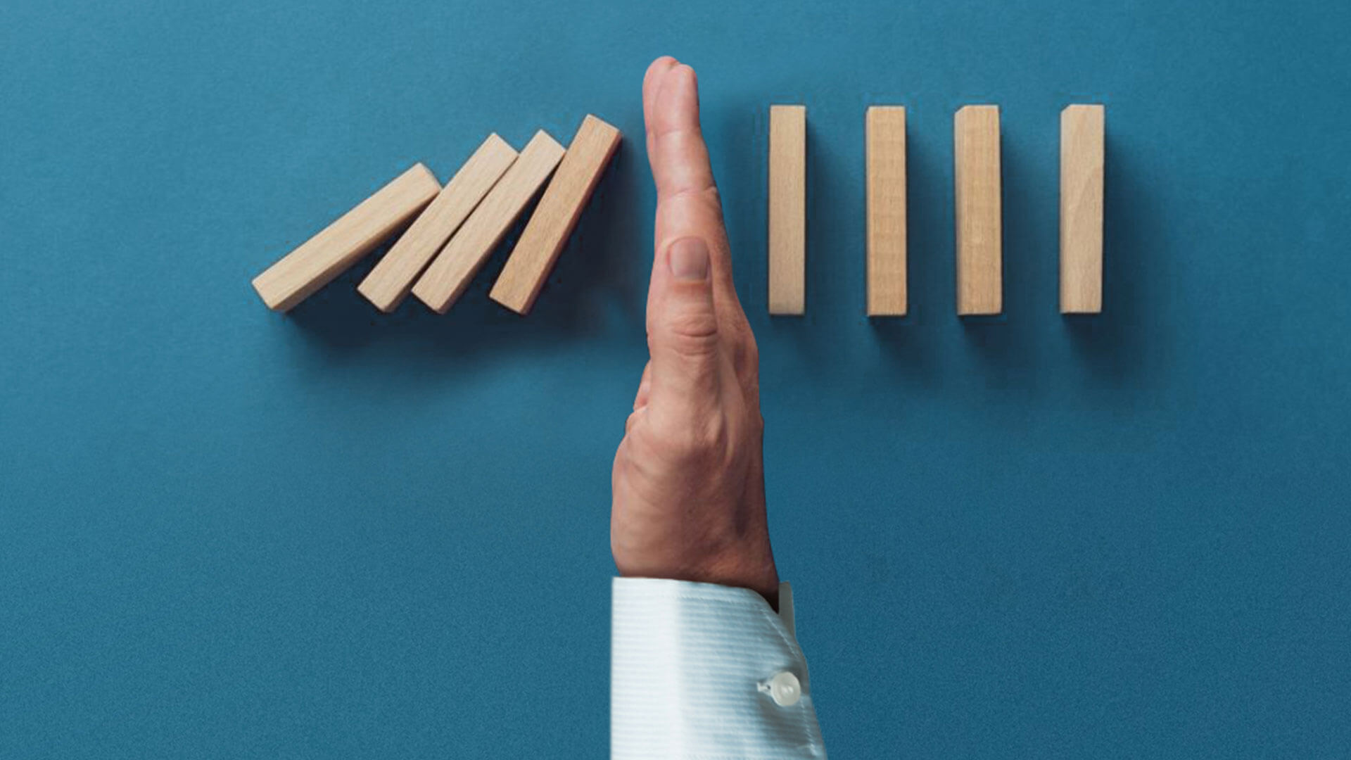 A hand in the middle of some dominoes