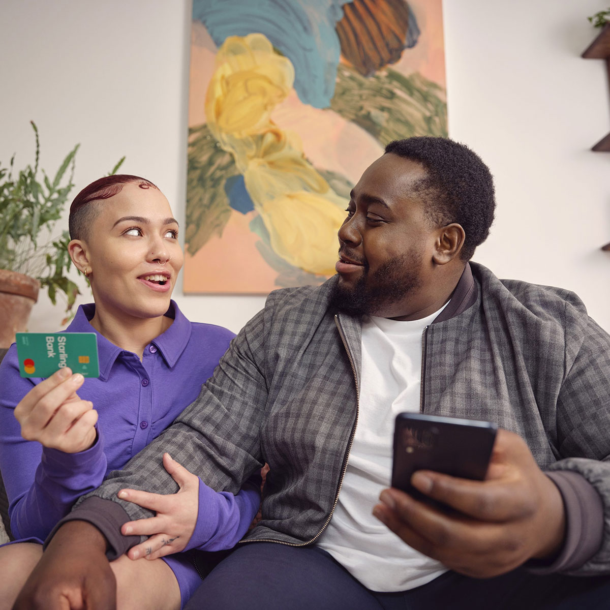 A man and a lady on a chair with a Starling card