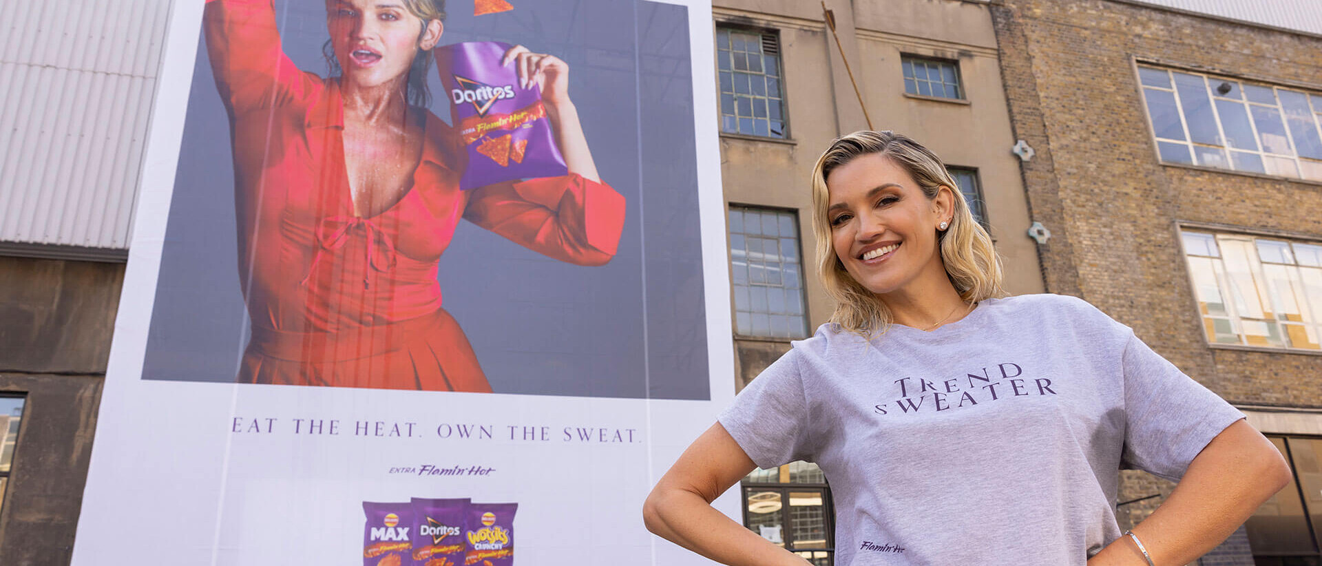 Ashley Roberts in front of a billboard